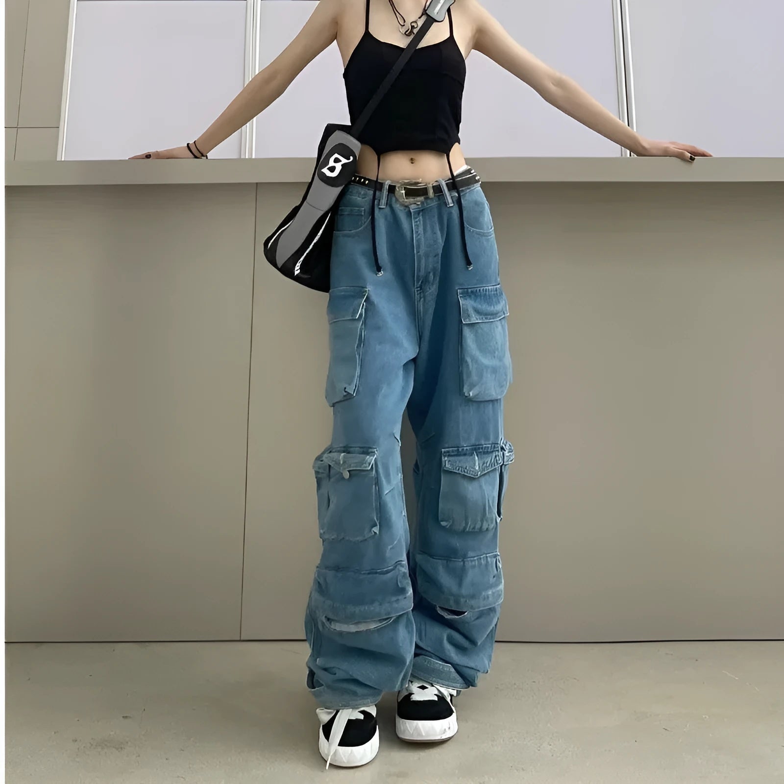 Blue tie-dyed high waist wide leg denim trousers on a woman, showing multiple pockets and street hipster style.