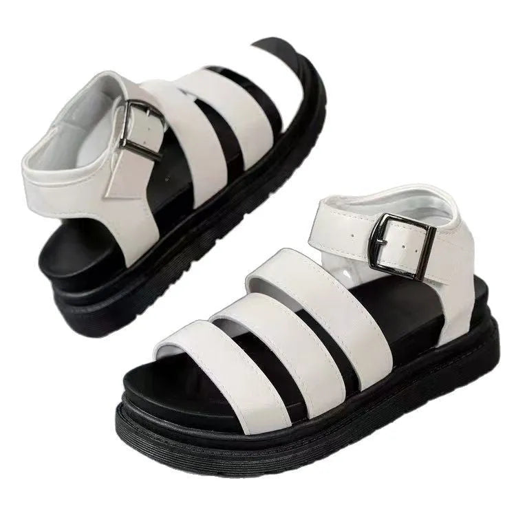 Pair of thick-soled black sandals with an adjustable buckle strap over the instep.