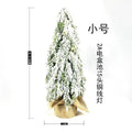 24-inch small artificial Christmas tree with snow spray decoration and built-in lights on desktop