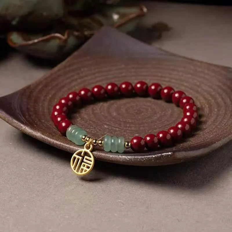 Gold cinnabar and copper wave bracelet in pumpkin or brand colour on wrist.