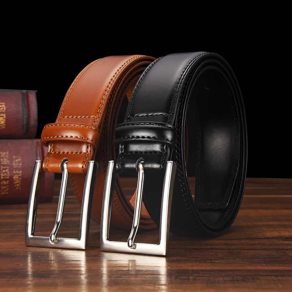 Men's black leather belt with silver alloy pin buckle showing two-layer cowhide construction
