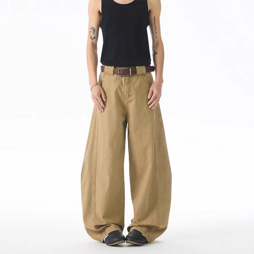 Brown men's loose fit straight leg jeans with a button fly on a mannequin.