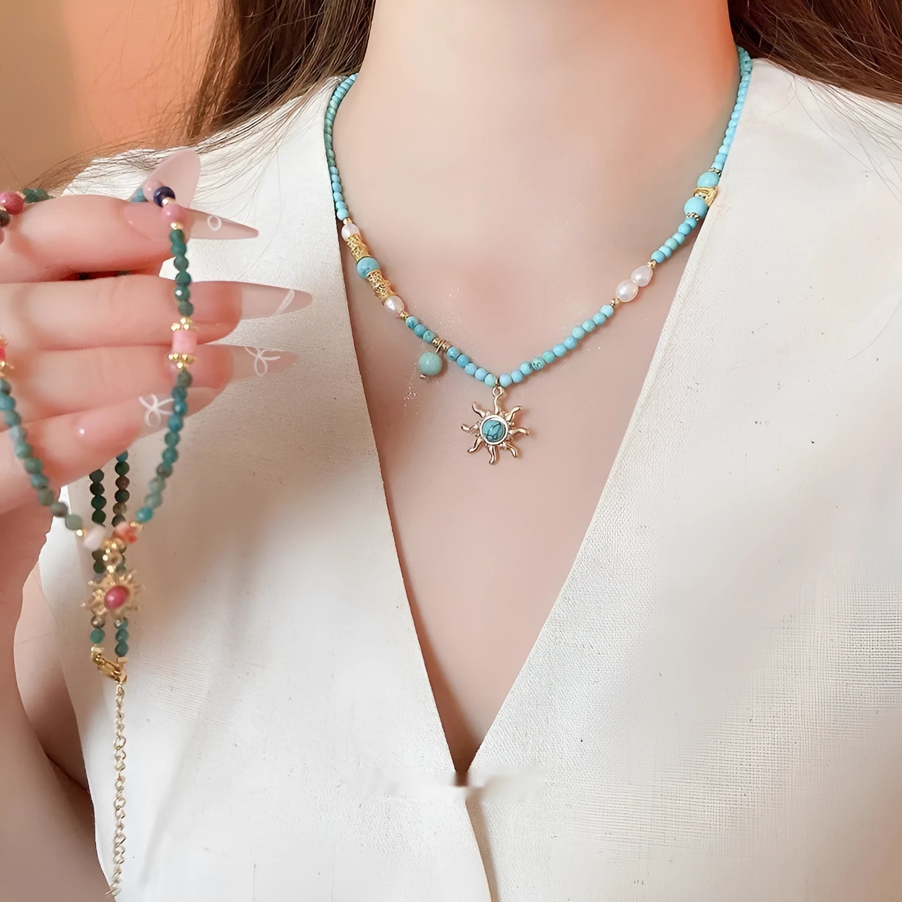 Stone sun pendant and freshwater pearl French court style necklace on a model