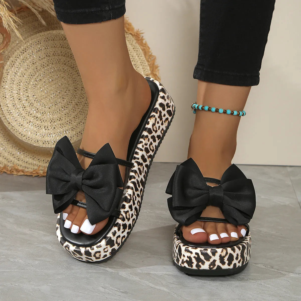 Leopard print women's slippers with thick sole and round toe in black or white.