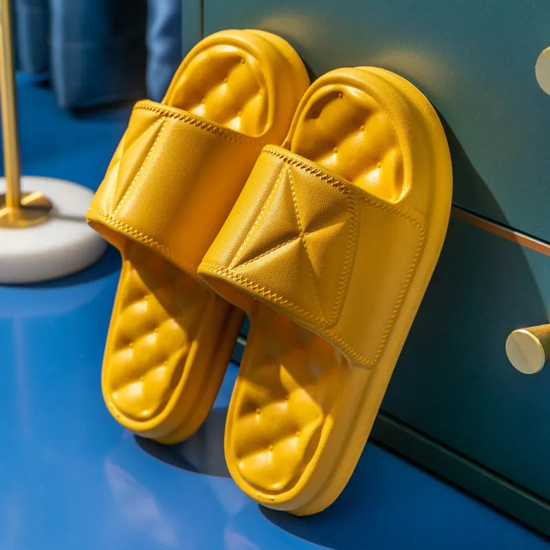Pair of thick-soled EVA bathroom slippers in various colours, showing non-slip sole texture.