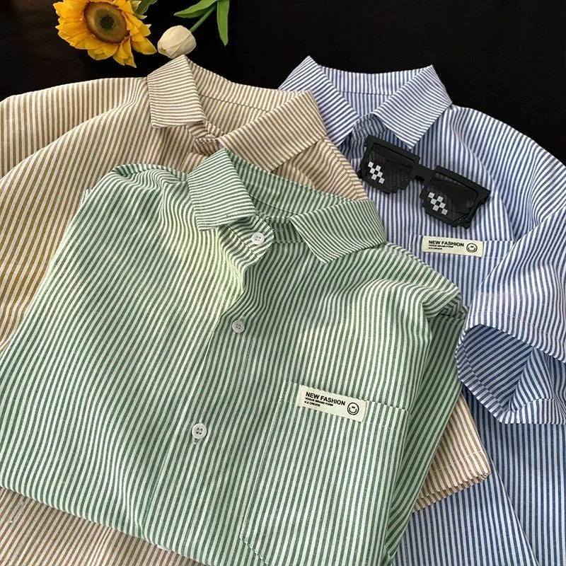Blue and green striped loose plus size half sleeve polyester shirt on hanger