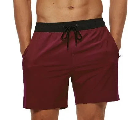 Men's blue fitness shorts with stitched waist headband, drawstring, zipper pocket, and padding for running