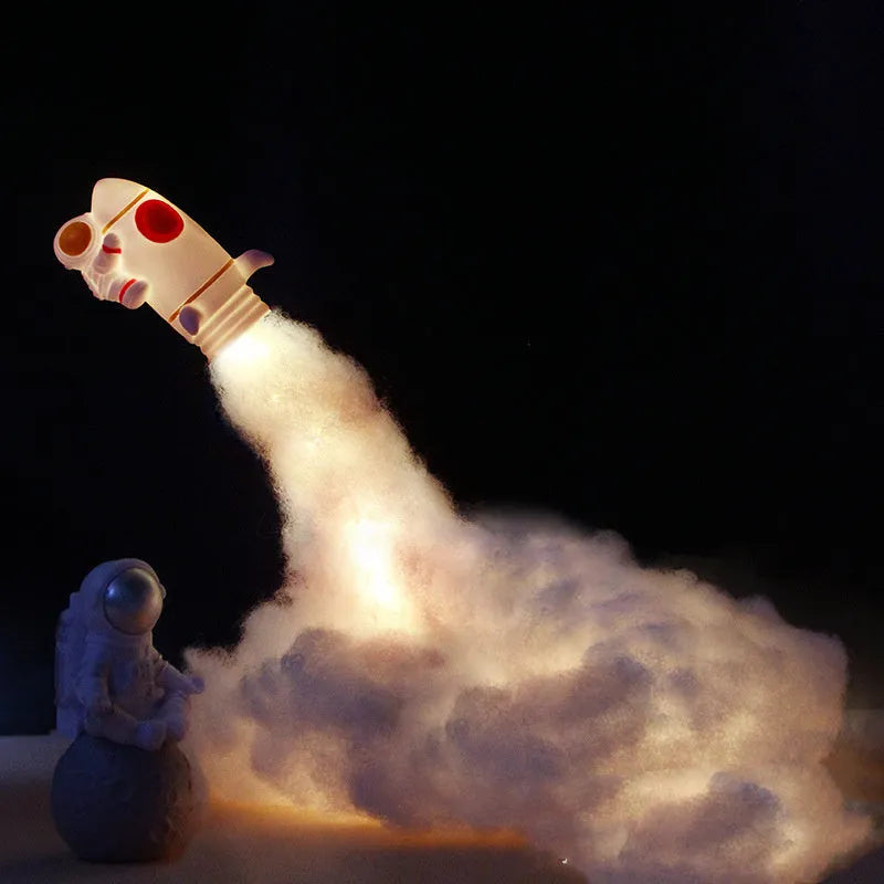 DIY astronaut rocket night light kit with LED string lights and build materials on a desktop