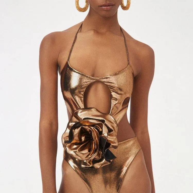 Gold coloured handmade one-piece swimsuit with halter neck and hollow out pattern.