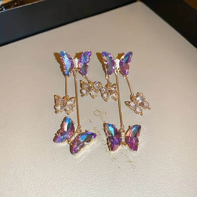 Silver electroplated butterfly tassel earrings with blue-purple crystal flowers on alloy base