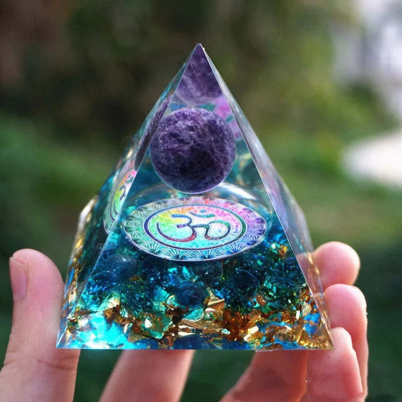 Clear epoxy resin pyramid ornament with embedded coloured crystal gravel inside, measuring 6cm.