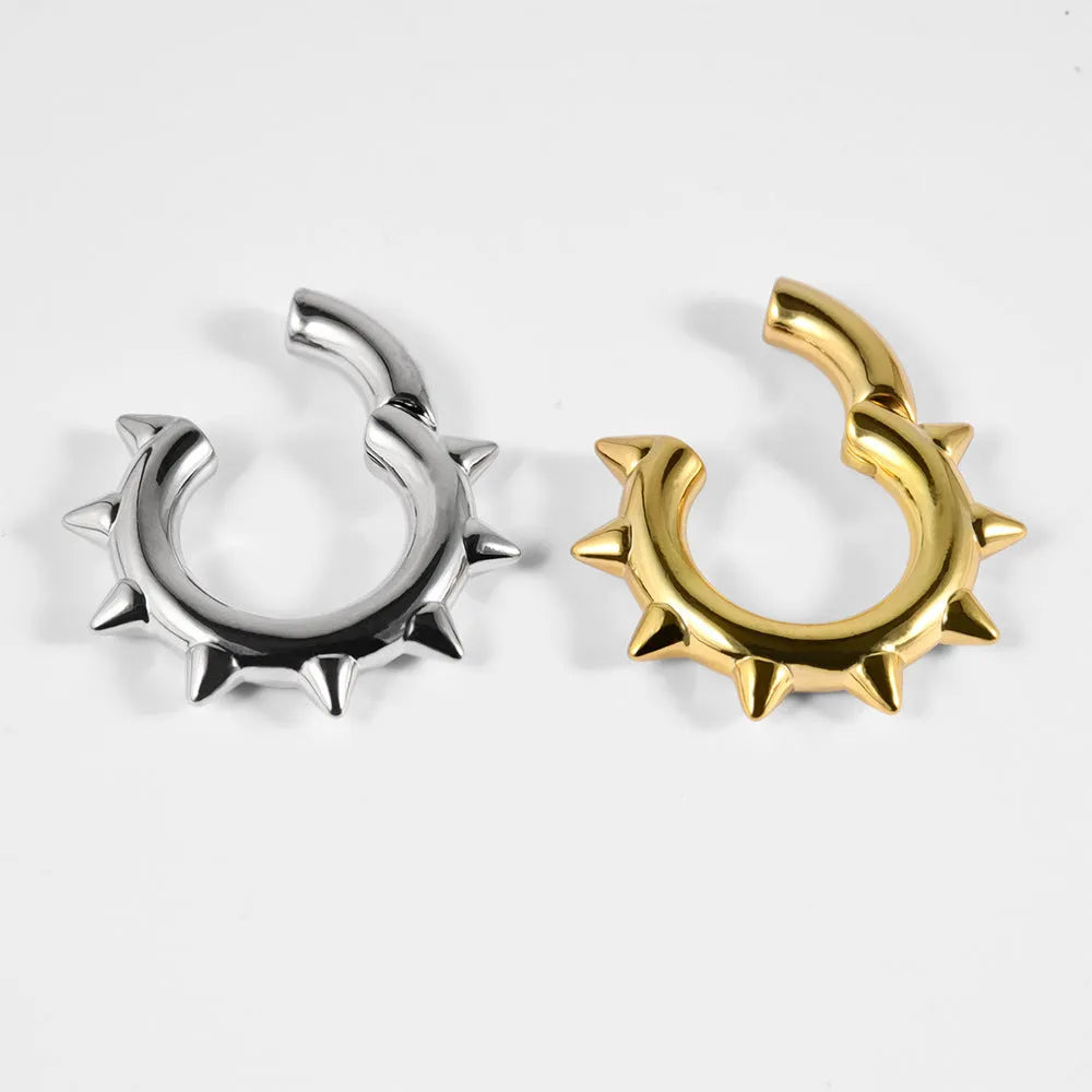 Copper geometric cone-shaped magnetic ear stretcher plugs with round magnetic closure on ear lobe.