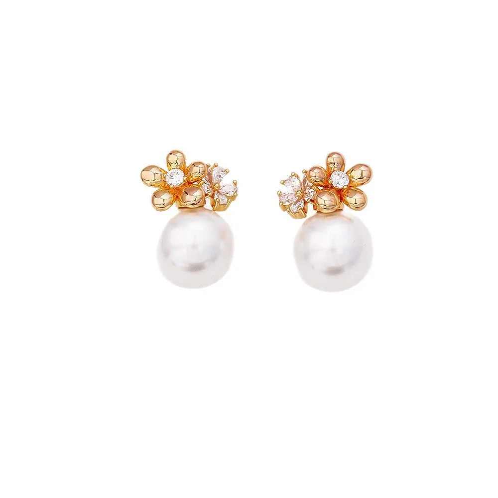 Pair of geometric round pearl and zircon stud earrings in gold plated finish on copper base