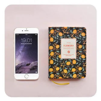 Green fabric imitation leather floral notepad open on a desk, showing custom logo printing and Daolin paper.