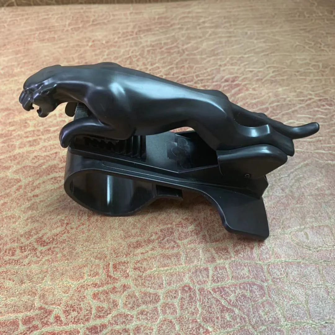 Black car phone holder with rotating bracket mounted on a windscreen