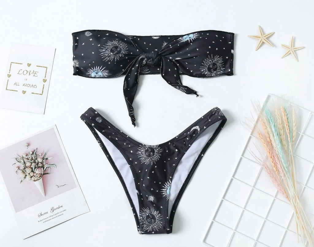 Black printed one-piece swimsuit with a backless design for women, made from nylon.