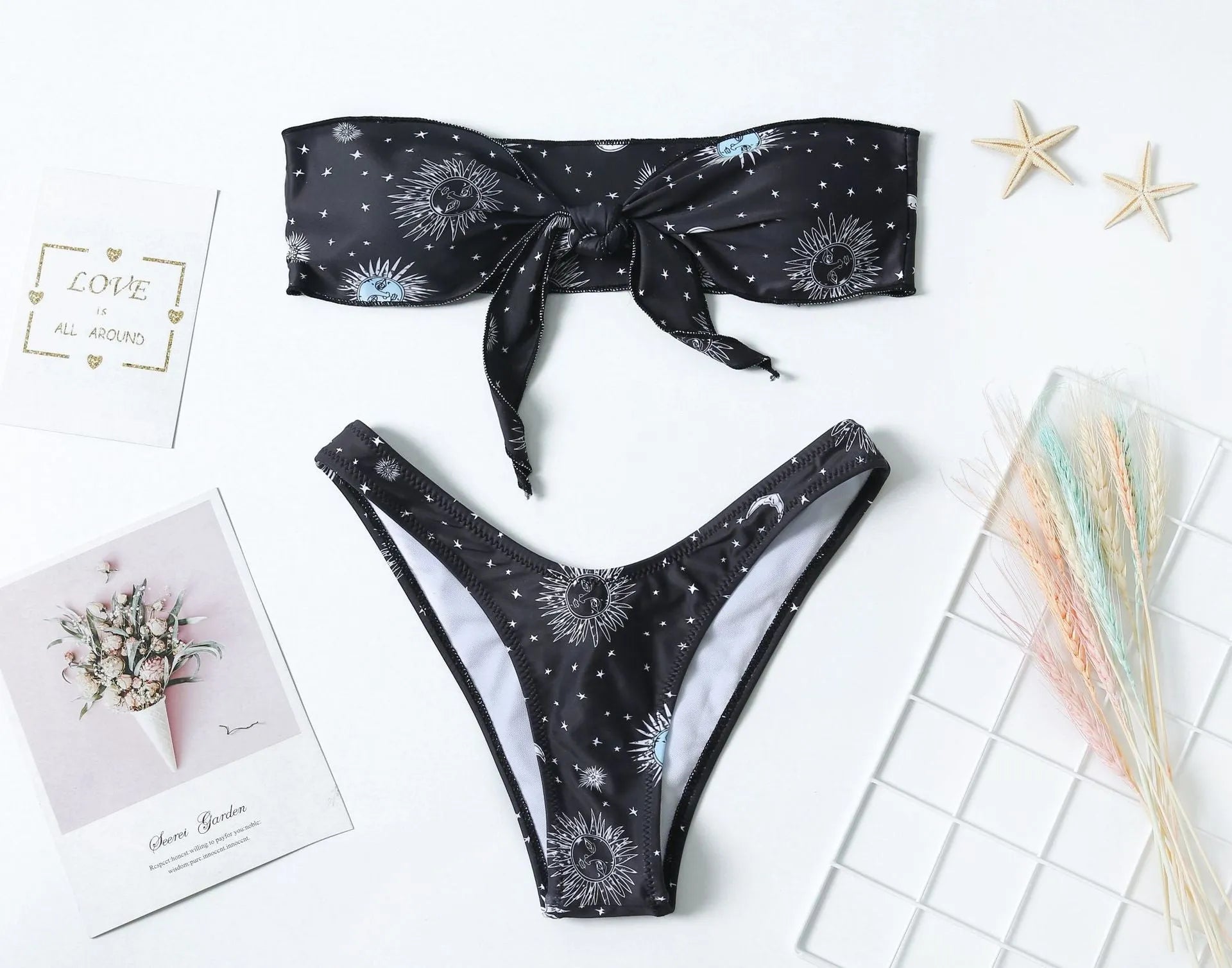 Black printed one-piece swimsuit with a backless design for women, made from nylon.