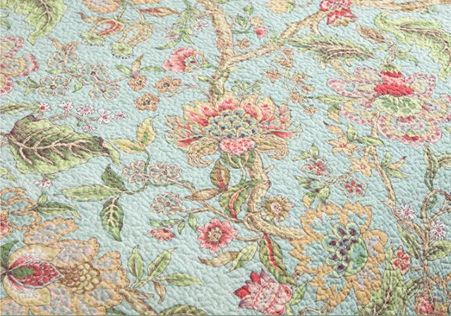 Blue American flower and bird pattern cotton bedspread set with three pieces shown on a bed