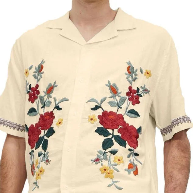 Men's apricot-coloured short-sleeve shirt with vintage floral print and lapel collar on a hanger.