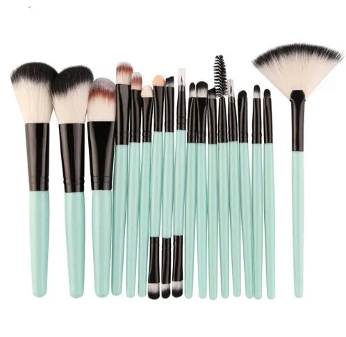 18-piece makeup brush set with fan brushes arranged on a table.