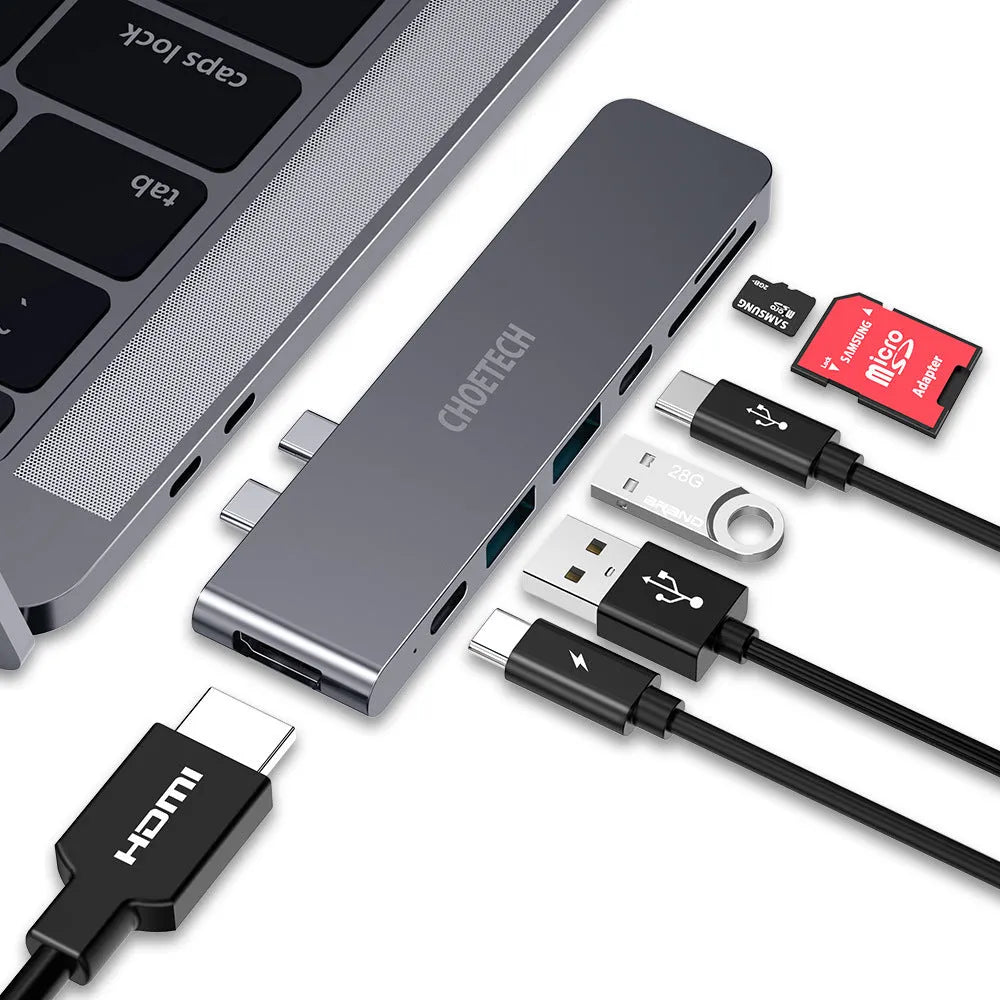 Silver aluminium USB-C multi-port adapter hub with SD card slot, HDMI, USB ports, and Power Delivery.