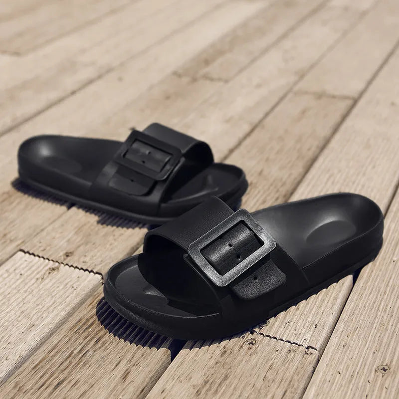 Grey Blue women's EVA flip-flop slippers with a silver buckle strap on a white background.