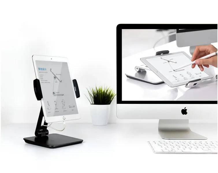 Silver aluminium and ABS folding stand holding a tablet, showing 360-degree rotation and anti-slip silicone pads.