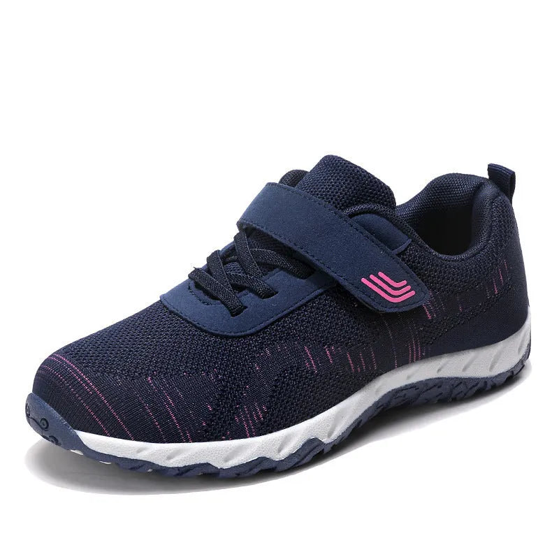 Women's low-top sneakers with Velcro straps and a wedge heel, in a mesh upper and solid colour.