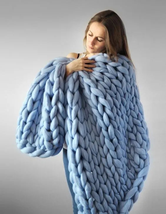Hand woven chenille blanket in dark grey colour draped over a sofa, available in multiple sizes