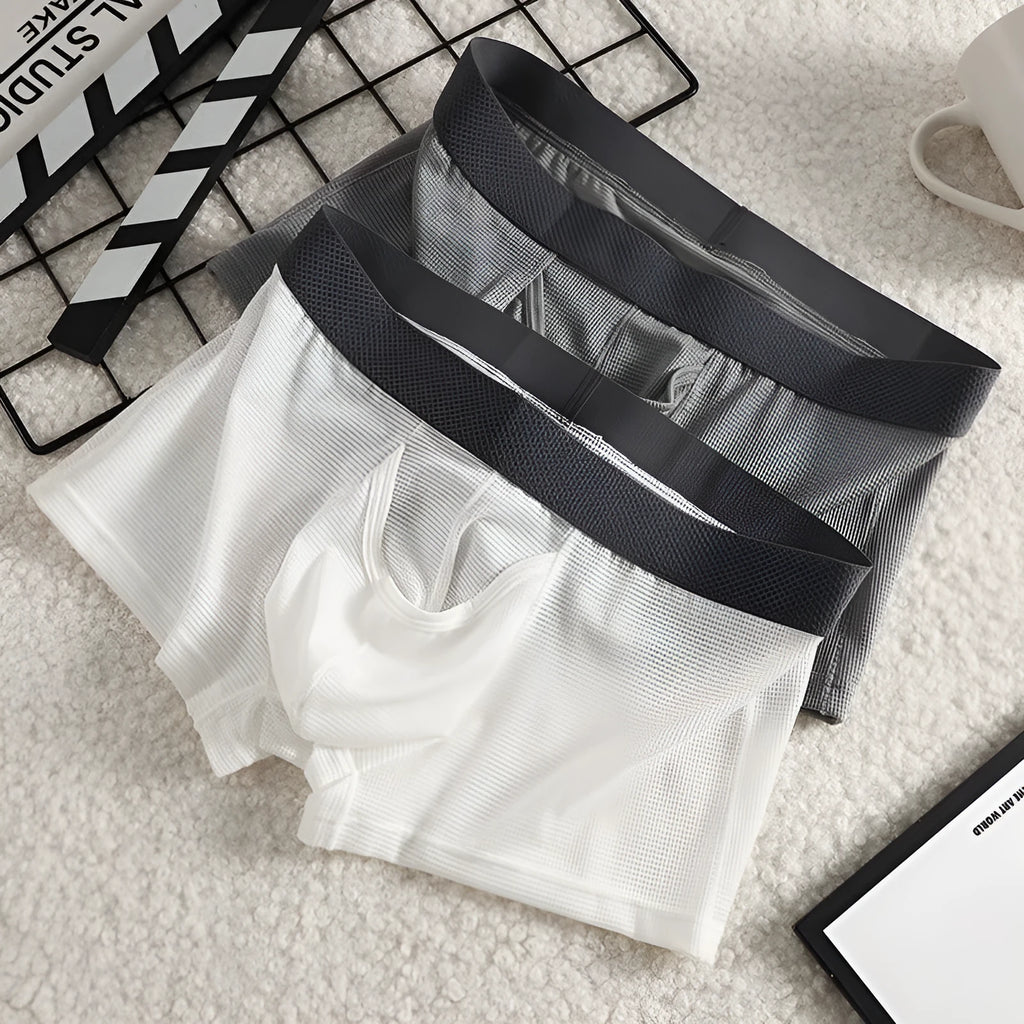 Men's low waist ice silk boxer briefs in black, shown flat.