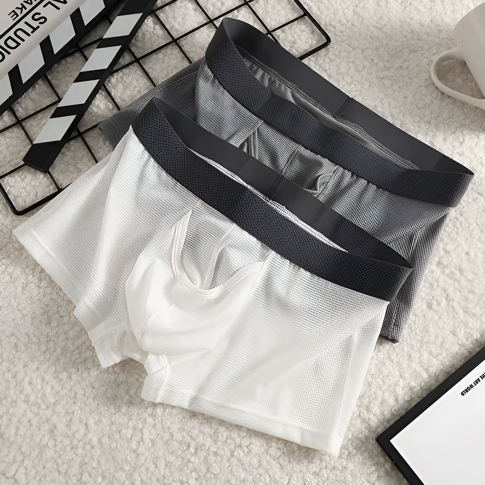 Men's low waist ice silk boxer briefs in black, shown flat.
