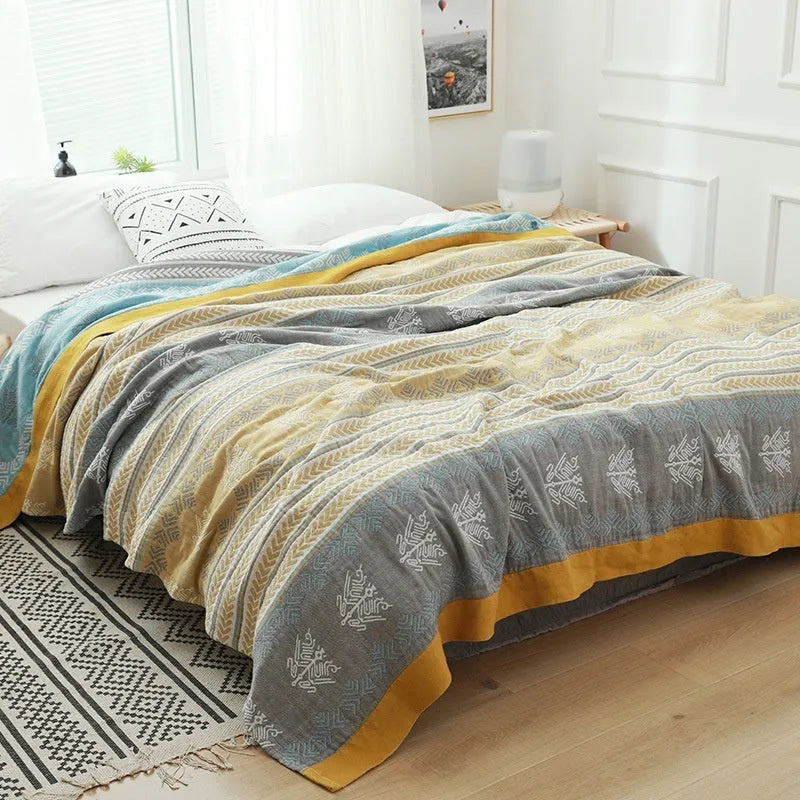 Roulette Wheel Blue five-layer gauze cotton bed blanket on a bed, showing Modern Simplicity pattern.