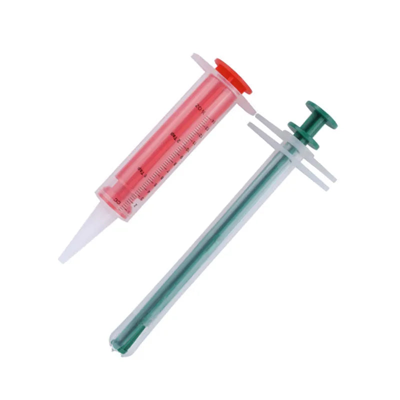 Two pet pill shooters with soft silicone tips for administering tablets to cats and dogs.