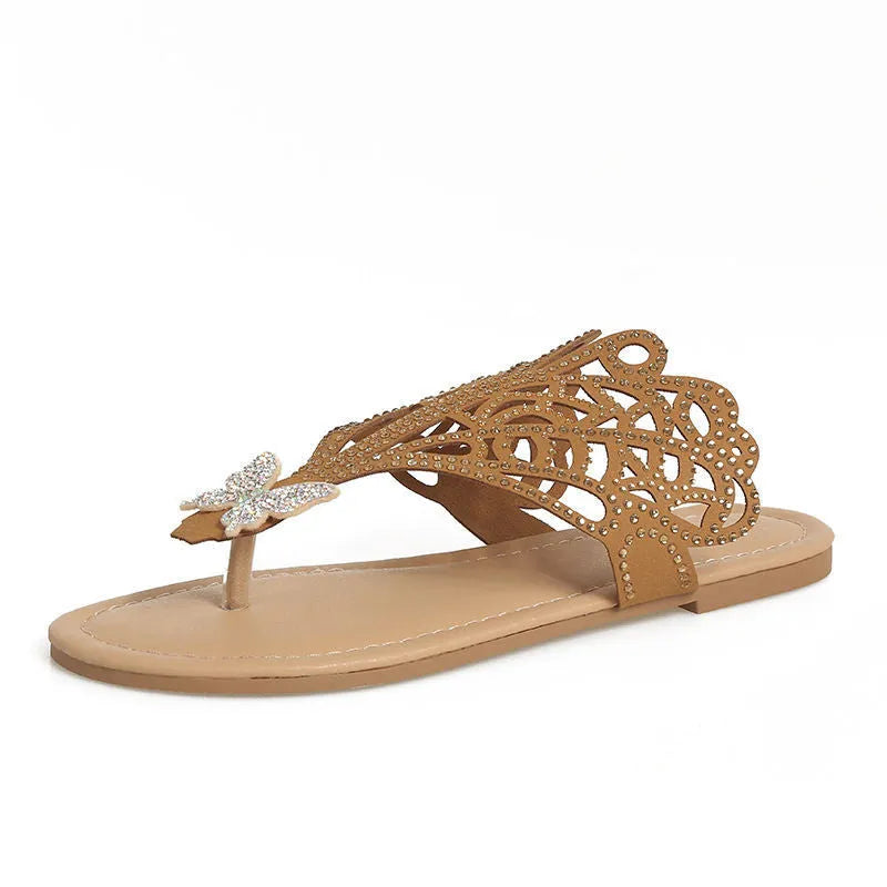 Women's black slip-on sandals with rhinestone decoration and flip-toe design.