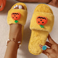 White and yellow Halloween pumpkin plush open toe slippers on anti-slip PVC sole.