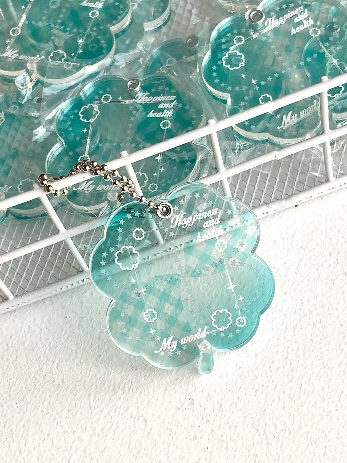 Acrylic four-leaf clover mobile phone pendant keychain in blue, green, and mint colours