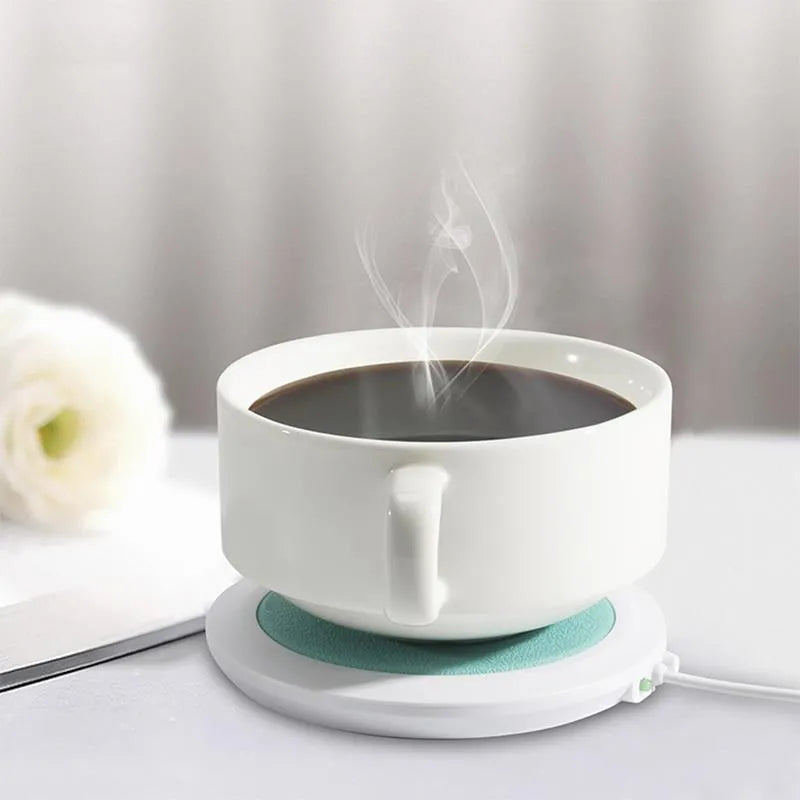 Black USB-powered high temperature heater with insulated base on a desk.