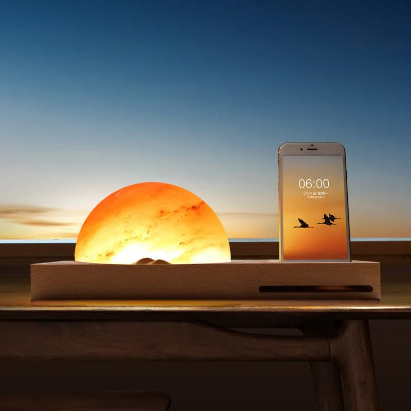 Natural crystal salt lamp with solid beech wood base and integrated Qi wireless phone charging pad.