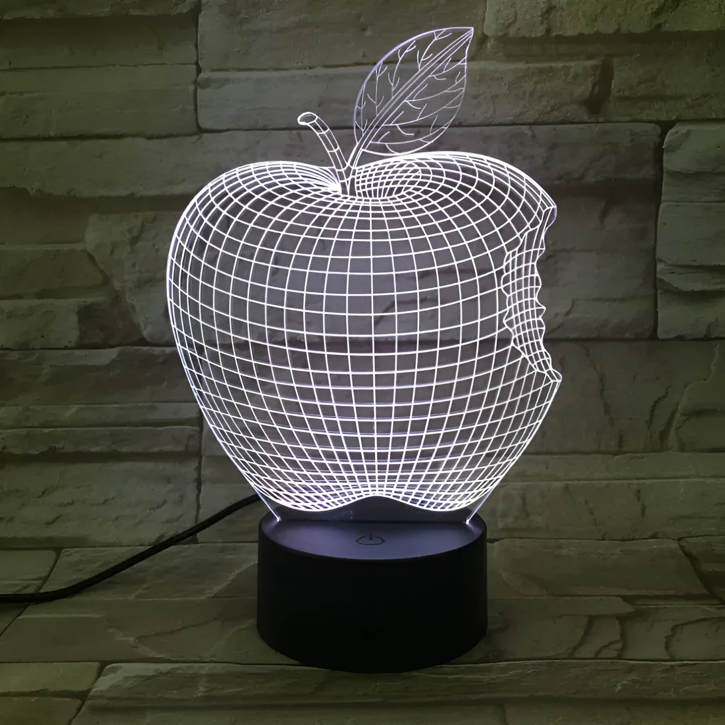 3D fruit-shaped colourful night light with touch controls and acrylic shade on a surface.