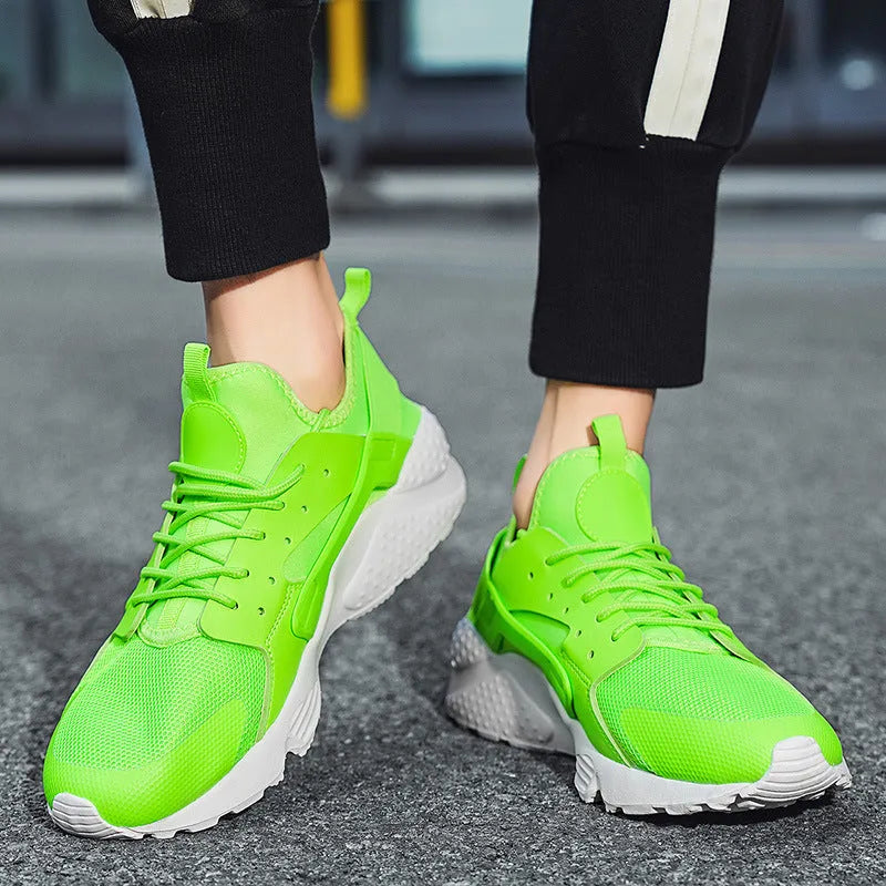 Men's green low top mesh casual shoes with lace-up front and cross straps on a flat sole.