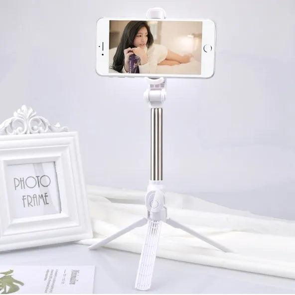 Bluetooth remote control mobile phone tripod stand extended with phone attached