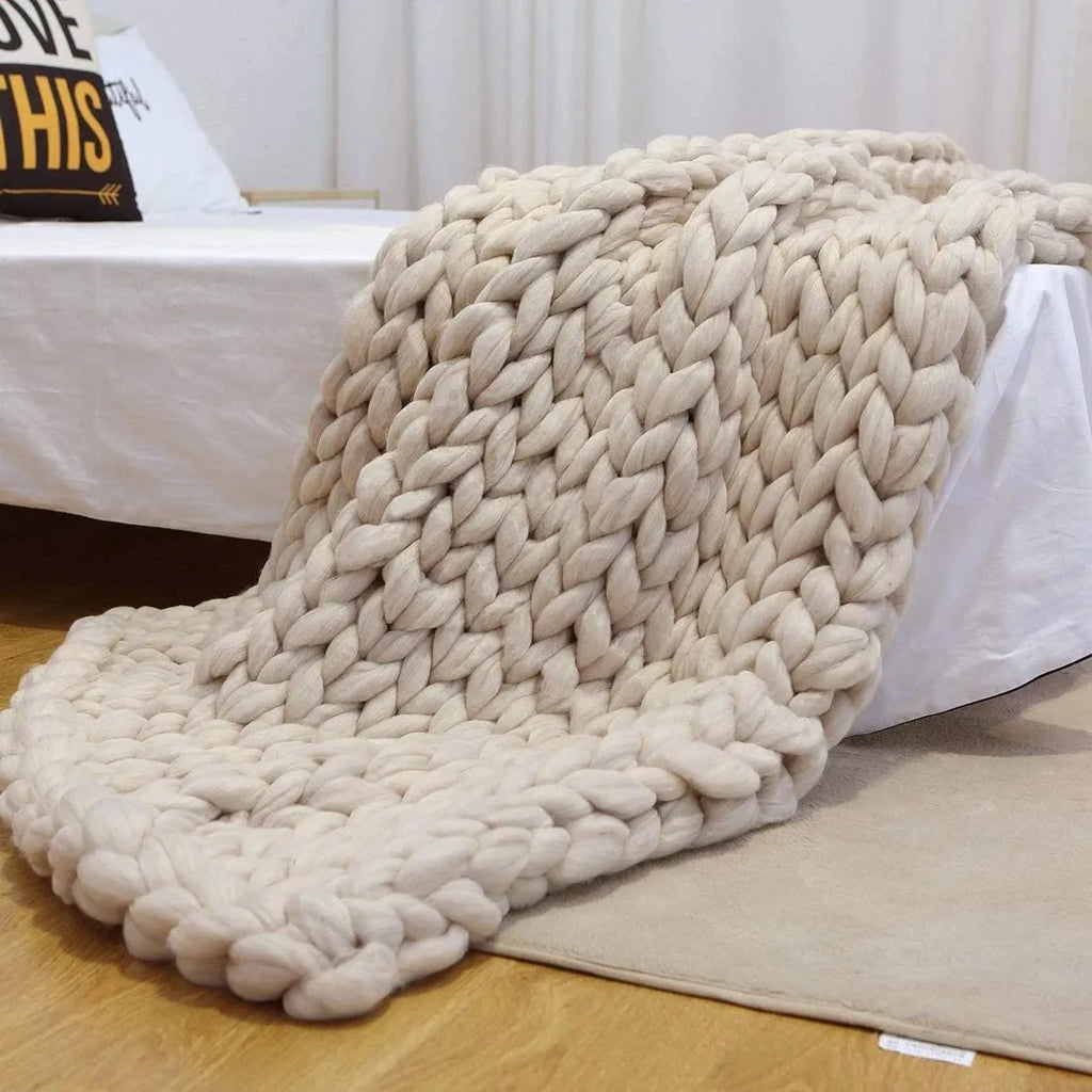Hand woven chenille blanket in dark grey colour draped over a sofa, available in multiple sizes