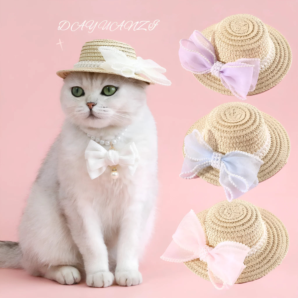 A woven Lafite leaf straw hat for a cat, decorated with a pearl butterfly bow, shown in pink, purple, blue, and white colour options.