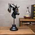 Tall black natural resin animal sculpture decoration on a wooden shelf.