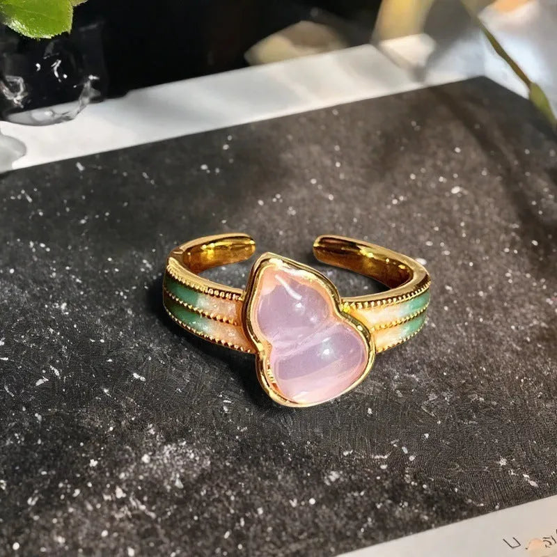 Adjustable Chinese gourd ring with zircon inlay showing floral and bow elements in oil-drip finish
