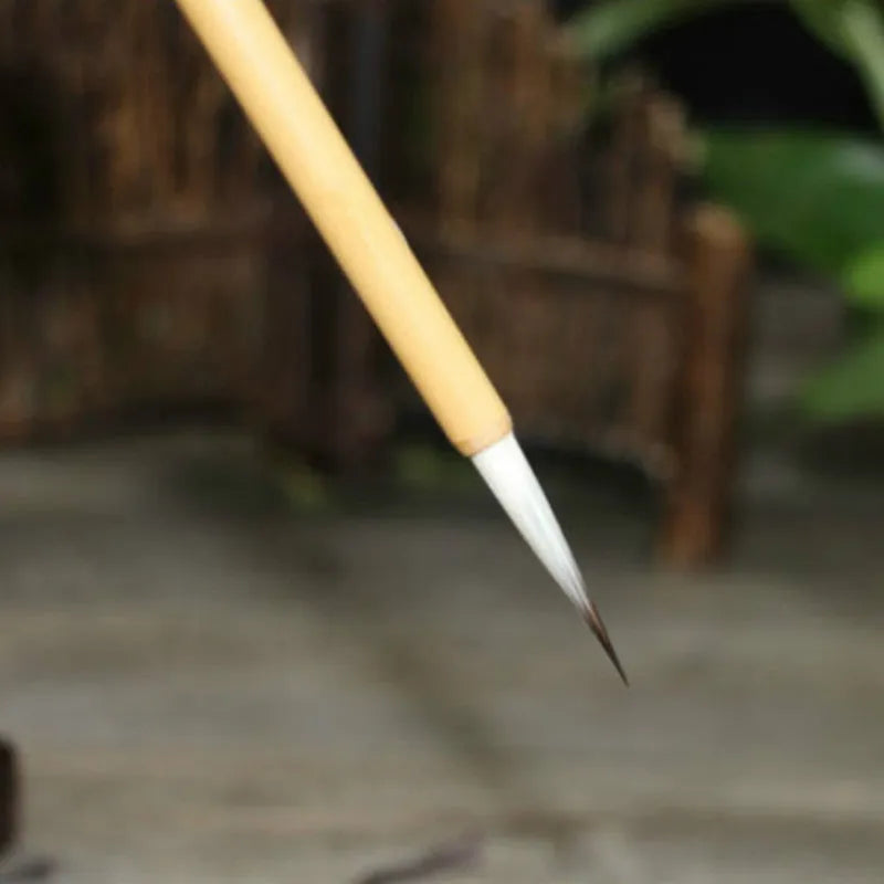 Four fine lower case writing brushes with thin gold body and mixed hair bristles in pine branch colour