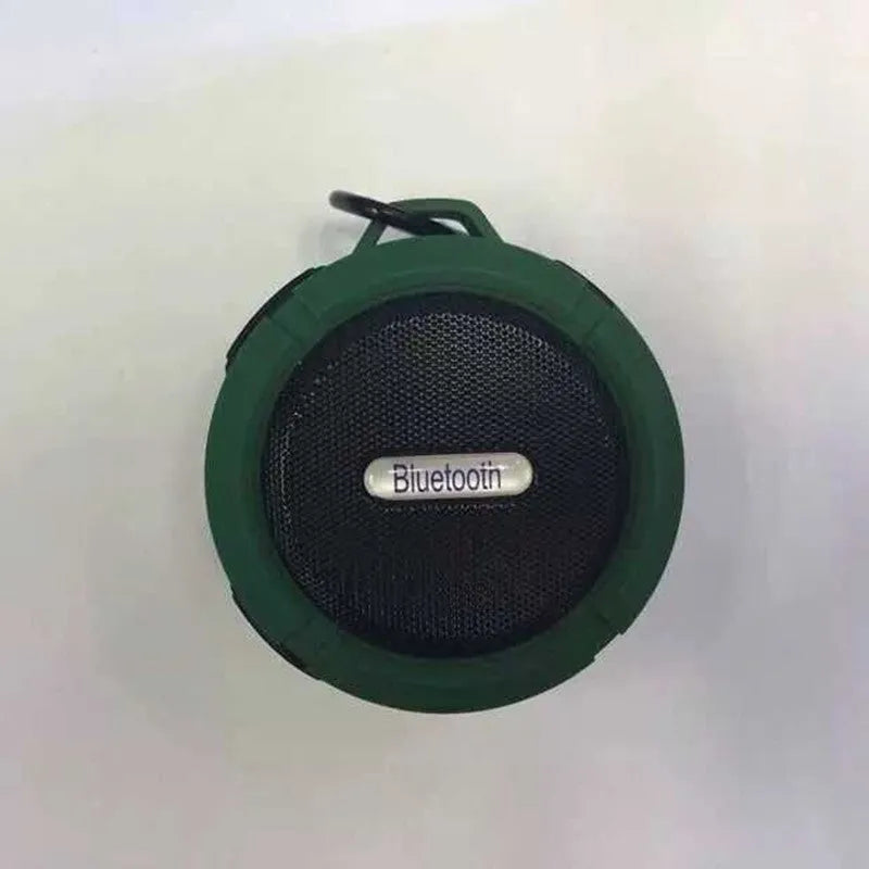 Portable waterproof Bluetooth speaker in multiple colours with a mountaineering buckle for bag attachment.