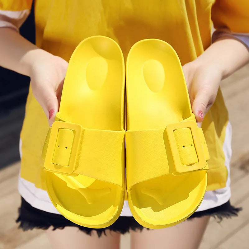 Grey Blue women's EVA flip-flop slippers with a silver buckle strap on a white background.