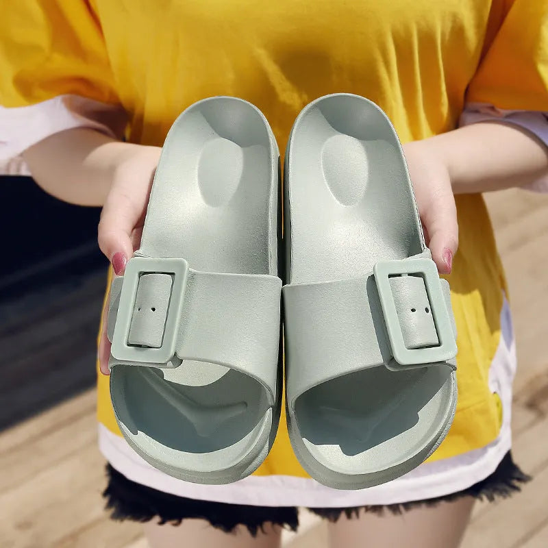 Grey Blue women's EVA flip-flop slippers with a silver buckle strap on a white background.