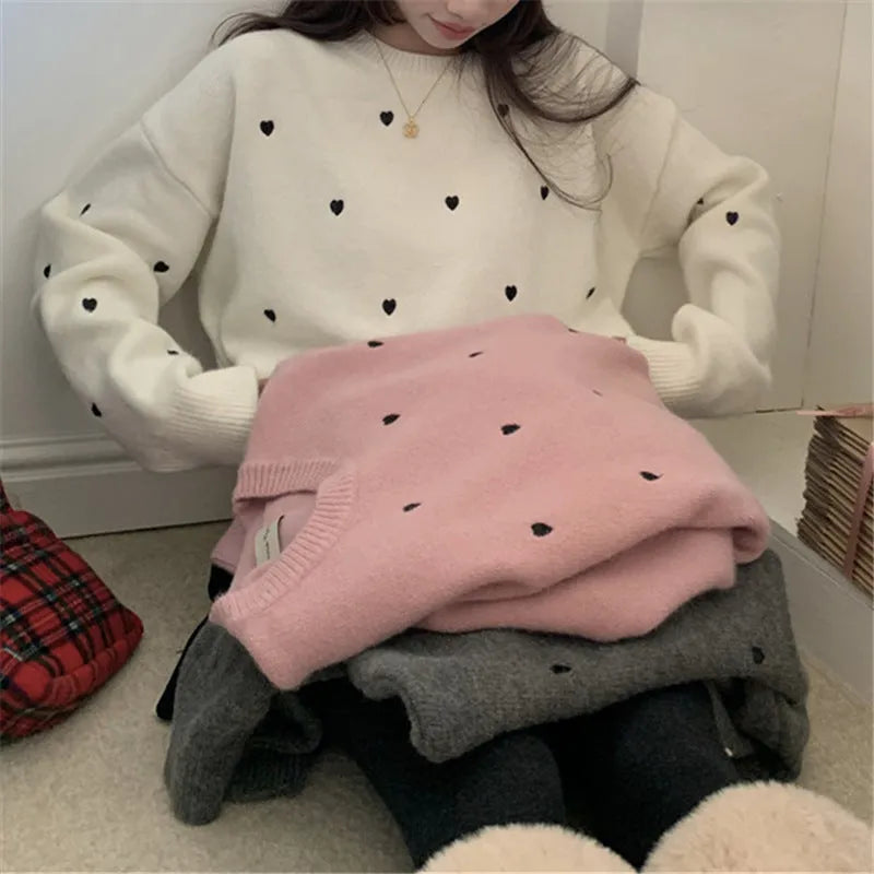 Women's loose fit acrylic pullover sweater with embroidered love pattern in milky white.
